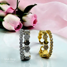 Gold and silver Chaumet-inspired connected double rings displayed with pink roses