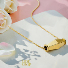 Close-up of the faceted gold olive bead pendant and delicate chain