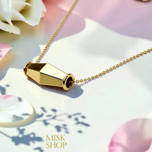 Angled detail of the polished gold olive bead pendant