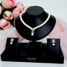 Chanel inspired pearl necklace and earrings set with zircon details on black display