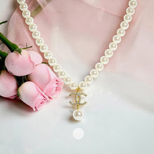 Close-up of cultured pearl necklace with zircon Chanel inspired pendant