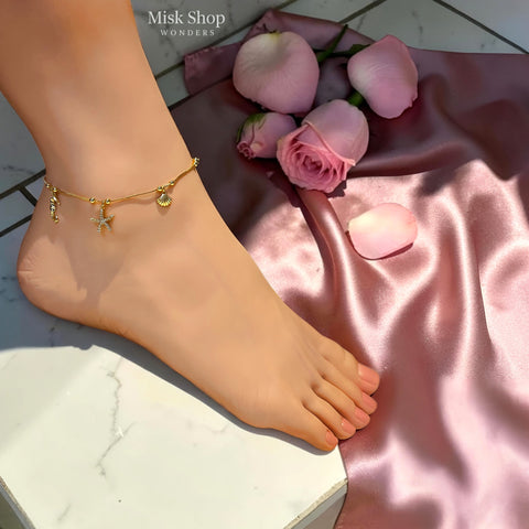Adjustable 18K gold plated stainless steel marine charm anklet with a zircon starfish, seahorse and shell by Misk Shop.