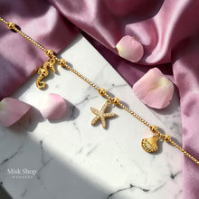 Adjustable 18K gold plated stainless steel marine charm anklet with a zircon starfish, seahorse and shell by Misk Shop.