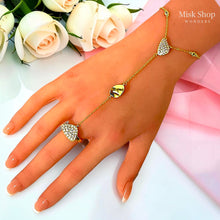 Full view of an APM Monaco inspired gold hand chain ring with pavé zircon