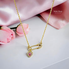Medium-length 18K gold plated titanium steel safety pin necklace with a pink heart charm and 3A zircon stones by Misk Shop.