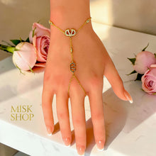 Full view of a Valentino inspired VLogo hand chain with zircon details