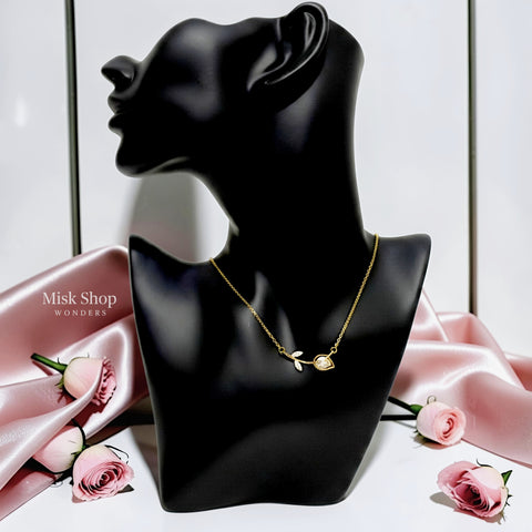Medium-length 18K gold plated titanium steel rose stem necklace with a white bud detail and 3A zircon leaves by Misk Shop.
