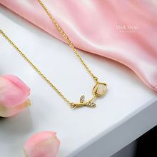 Medium-length 18K gold plated titanium steel rose stem necklace with a white bud detail and 3A zircon leaves by Misk Shop.