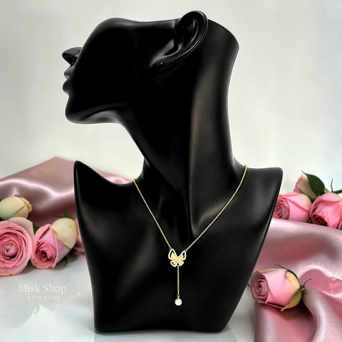 Misk Shop 18K gold plated 304 stainless steel butterfly necklace with zircon and a cultured pearl drop displayed on a black jewelry bust