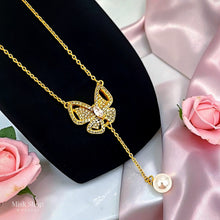 Close-up of Misk Shop 18K gold plated butterfly necklace with zircon detailing and a cultured pearl drop
