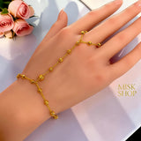 21K gold plated bubble bead hand chain bracelet worn across the hand