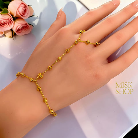 21K gold plated bubble bead hand chain bracelet worn across the hand