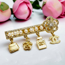Handcrafted 21K gold plated Chanel-inspired charm brooch with pearls and zircon stones by Misk Shop.