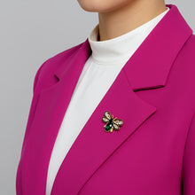 Handcrafted 21K gold color bee brooch with baguette zircon wings, black enamel details and emerald green crystal by Misk Shop.