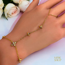Close-up of floral zircon details on a 21K gold plated hand chain bracelet