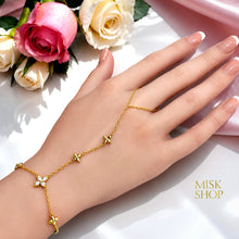 Gold floral zircon hand chain bracelet styled on a woman's hand