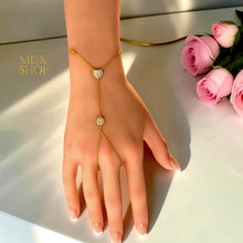 Full view of a 21K gold plated heart and sun hand chain with finger loop