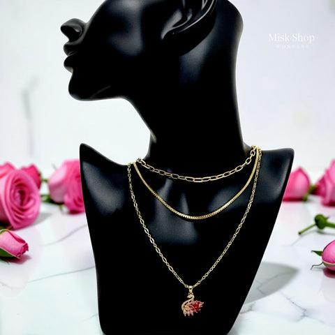 Luxury 21K gold color triple layer necklace featuring a pink swan pendant decorated with white and pink marquise zircon stones by Misk Shop.