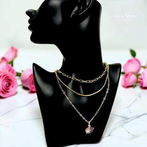 Luxury 21K gold color triple layer necklace featuring a purple swan pendant decorated with white and purple marquise zircon stones by Misk Shop.