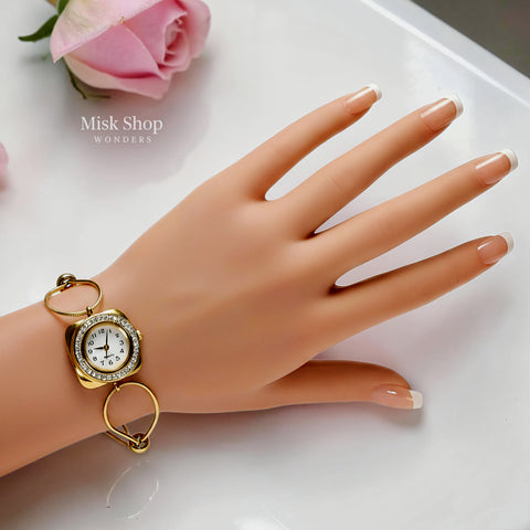 Women's gold bracelet watch with round ivory dial and zircon frame by Misk Shop.