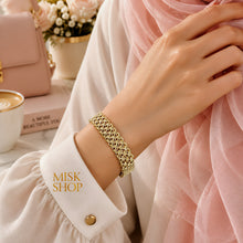 Wide flexible woven gold shawl bracelet with polished interlocking links worn on wrist