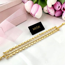 Connected 3-in-1 gold bracelet with rectangular zircon center and oval gold bead rows laid flat