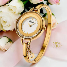 Binda yellow gold plated bangle watch with moving crystals and a padlock charm
