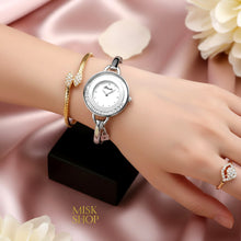 Binda white gold plated moving crystal bangle watch styled on the wrist; other jewelry not included