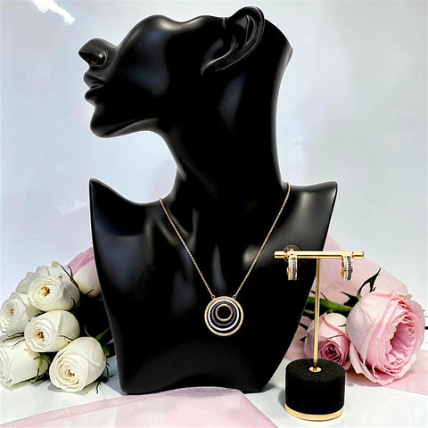Boucheron-inspired gold plated necklace and hoop earrings set displayed with flowers