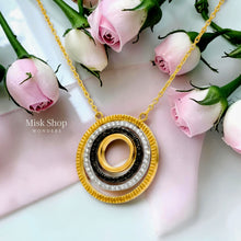 Close-up of layered circular pendant on Boucheron-inspired gold plated necklace