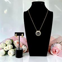 Complete gold plated necklace and earrings set on black jewelry display