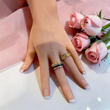 Two Boucheron-inspired multi-tone rings worn on hand