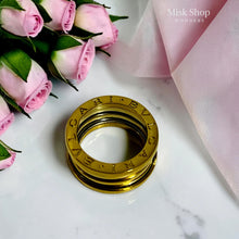 Top view of Bvlgari-inspired gold plated wide band ring with engraved lettering