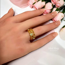 Gold-tone honeycomb open ring shown on hand