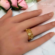 Close-up of gold-tone honeycomb adjustable ring on hand