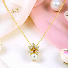 Close-up of gold-plated floral zircon necklace with cultured pearl drop