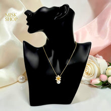 Side view of cultured pearl and floral zircon pendant necklace