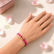 Fuchsia CD link leather bracelet worn on wrist