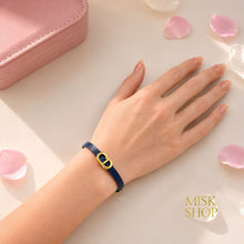 Navy CD link leather bracelet worn on wrist