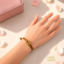 Tan CD link leather bracelet worn on wrist
