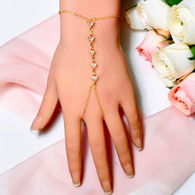Front view of gold-tone stainless steel hand chain bracelet with five triangle zircon stones