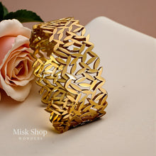 Close up detail of bold nature inspired 21K gold plated bracelet
