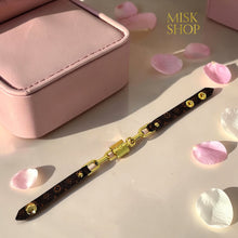 Full view of LV-inspired brown monogram adjustable leather bracelet