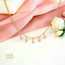 Marquise zircon drop ball chain choker displayed on pink satin