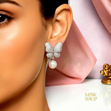 White gold plated butterfly and cultured pearl drop earring with high-transparency zircon worn on a model