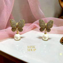 Close-up of 18K yellow gold plated butterfly earrings with high-transparency zircon and cultured pearls