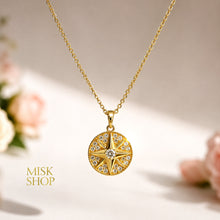 Close-up of the round eight-point compass star pendant with clear zircon stones