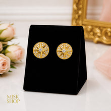 Matching circular compass star earrings with central zircon stones
