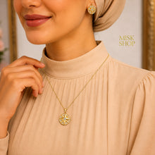 Compass star necklace and earrings styled with a beige outfit