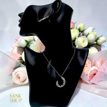 Silver open teardrop jewelry set on display